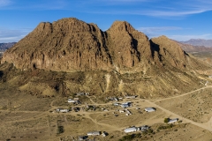 Bee Mountain, Study Butte, Texas. I think this is Bee Mountain at least. As you can see from the houses, this is a big chunk of rock sticking out of the desert. This was taken from 400ft elevation and is a panorama of 9 shots.